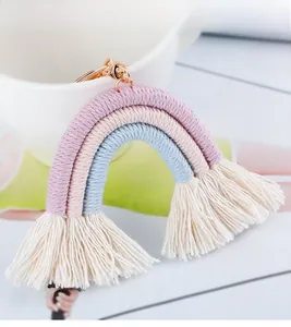 Detailed close-up of handmade rainbow keychain with three-tier cotton rope and soft fringe