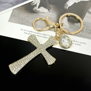Golden cross keychain with sparkling rhinestones and a pear-cut crystal pendant