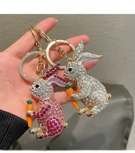 Detailed close-up of sparkling rhinestone bunny keychains held in hand with lobster clasps