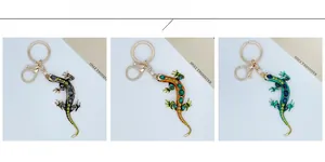 Three lizard keychains in grey, orange, and blue with rhinestone crystal embellishments