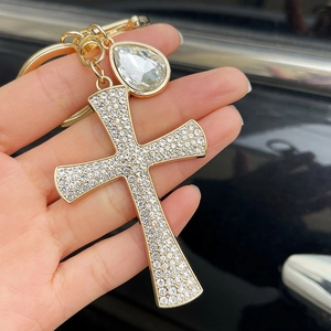 Luxurious gold cross keychain with clear rhinestones and a large teardrop zircon pendant