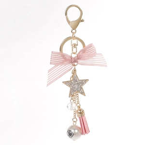 Pink ribbon bow keychain with star pendant, tassel, and pearl charm for handbags
