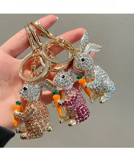 Detailed close-up of rabbit keychains with rhinestones and orange enamel carrots