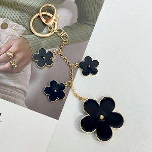 Elegant black and gold enamel five-petal flower keychain with stylish lobster clasp for bags