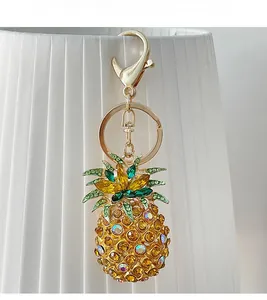 Detail of sparkling rhinestone pineapple keychain with golden frame and lobster clasp