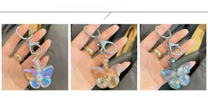 Detailed comparison of crystal butterfly keychains in iridescent white, champagne, and blue