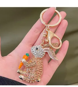 Close-up of golden bunny keychain with champagne rhinestones and an orange carrot charm