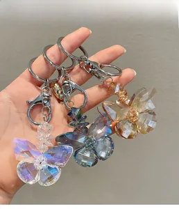 Macro detail of crystal butterfly keychains with multi-faceted cuts and silver metal rings