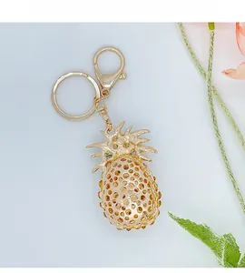 Detail of gold pineapple keychain with sparkling yellow rhinestones and hollow design