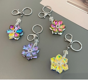 Macro shot of colorful crystal flower keychains with metallic rings and lobster clasps