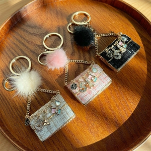 Elegant tweed handbag keychain with faux fur pompom and metal charms in three colors