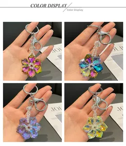 Detail showing crystal snowflake keychains in four colors with polished silver lobster clasps
