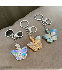 Detail showing crystal butterfly keychains in purple, amber and cyan with faceted surface