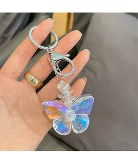 Macro shot of an iridescent crystal butterfly keychain with a silver spring clasp