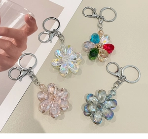 Detailed view of four beaded crystal flower keychains in diverse pastel color variants