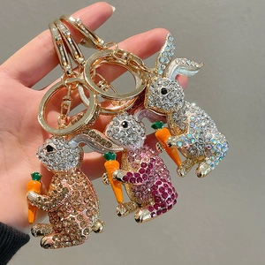 Cute cartoon rabbit keychain with sparkling rhinestones and carrot charm in hand