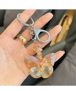 Close-up of faceted amber crystal butterfly keychain with silver metal lobster clasp