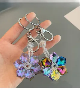 Detailed macro view of crystal snowflake keychains in purple and iridescent finishes