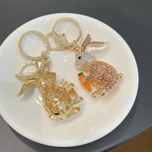 Creative rabbit keychain with colorful rhinestones and carrot charm on a white tray