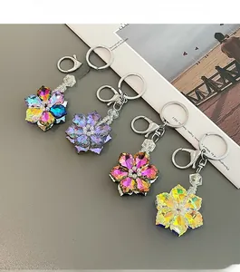 Detail of crystal flower keychains in multiple colors with faceted petals and silver clips