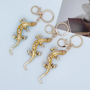 Three-piece gold lizard keychains with colorful crystals and lobster claw clasps