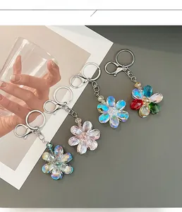 Detailed view of faceted crystal flower keychains in pastel colors with silver lobster clasps