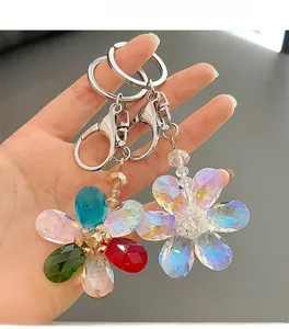 Detail of colorful and iridescent crystal flower keychains with polished metal clasps