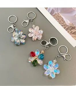Close-up of faceted crystal flower keychains with metallic ring and lobster clasp