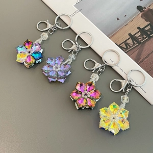 Elegant crystal flower keychains in four colors with polished silver alloy rings and hooks