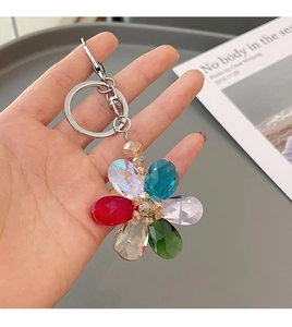 Close-up of a five-petal crystal flower keychain featuring multicolor faceted teardrop beads