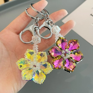 Sparkling crystal flower keychains with faceted petals in iridescent and purple colors