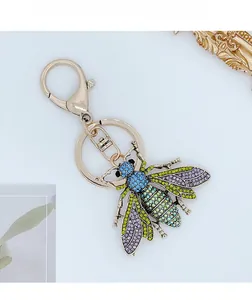 Detailed macro view of gold bee keychain with colorful rhinestones and lobster clasp
