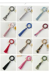 Color display of leopard print wristlet keychains with leather tassels and spiral bands