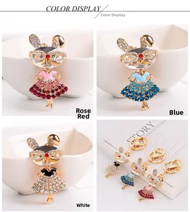 Detail showing crystal-encrusted bunny girl keychains in pink, blue, and white colors