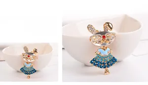 Close-up of sparkling crystal bunny girl brooch with blue gradient rhinestone dress
