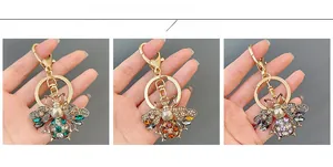 Detailed color display of cute crystal bee keychains in green, amber, and purple crystals