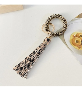 Close-up of leopard print phone cord keychain with stylish tassel and gold metal ring