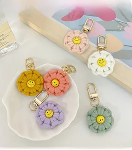 Close-up of handmade crochet flower keychains in six colors with smiling face centers