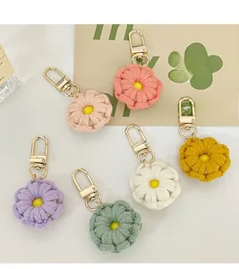 Detailed close-up of six colorful crochet flower keychains with golden metal lobster clasps