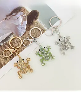 Detailed view of frog keychains with sparkling rhinestones in gold, green, and silver colors
