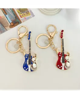 Détail de porte-clés guitare avec cristaux étincelants et perles en rouge et bleu