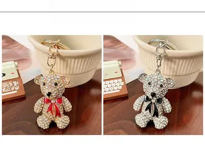 Close-up of sparkling rhinestone bear keychains in gold and silver with colorful bows