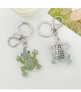 Front and back detail of crystal frog keychain with green rhinestones and silver metal base