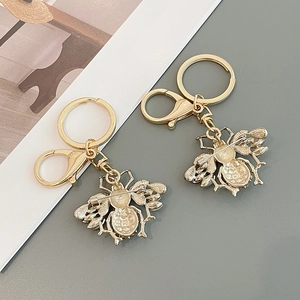 Exquisite golden bee keychain with detailed rhinestone wings and metallic insect texture