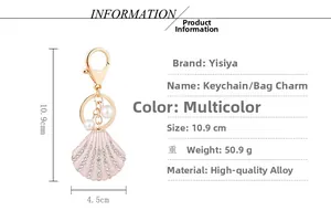 Detail view of pink shell keychain with crystals, pearls and size specs 10.9x4.5cm