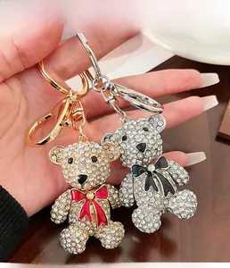 Close-up of gold and silver bear keychains with shimmering rhinestones and colorful bows