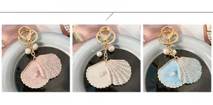 Detail view of rhinestone shell keychains with pearls in pink white and blue colors