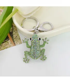 Detailed macro view of crystal frog keychain with green and blue rhinestones on silver ring