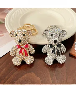 Close-up of gold and silver bear keychains with shimmering rhinestones and cute bowties