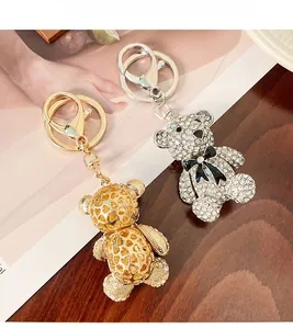 Detail of cute bear keychains featuring gold hollow heart and silver rhinestone designs